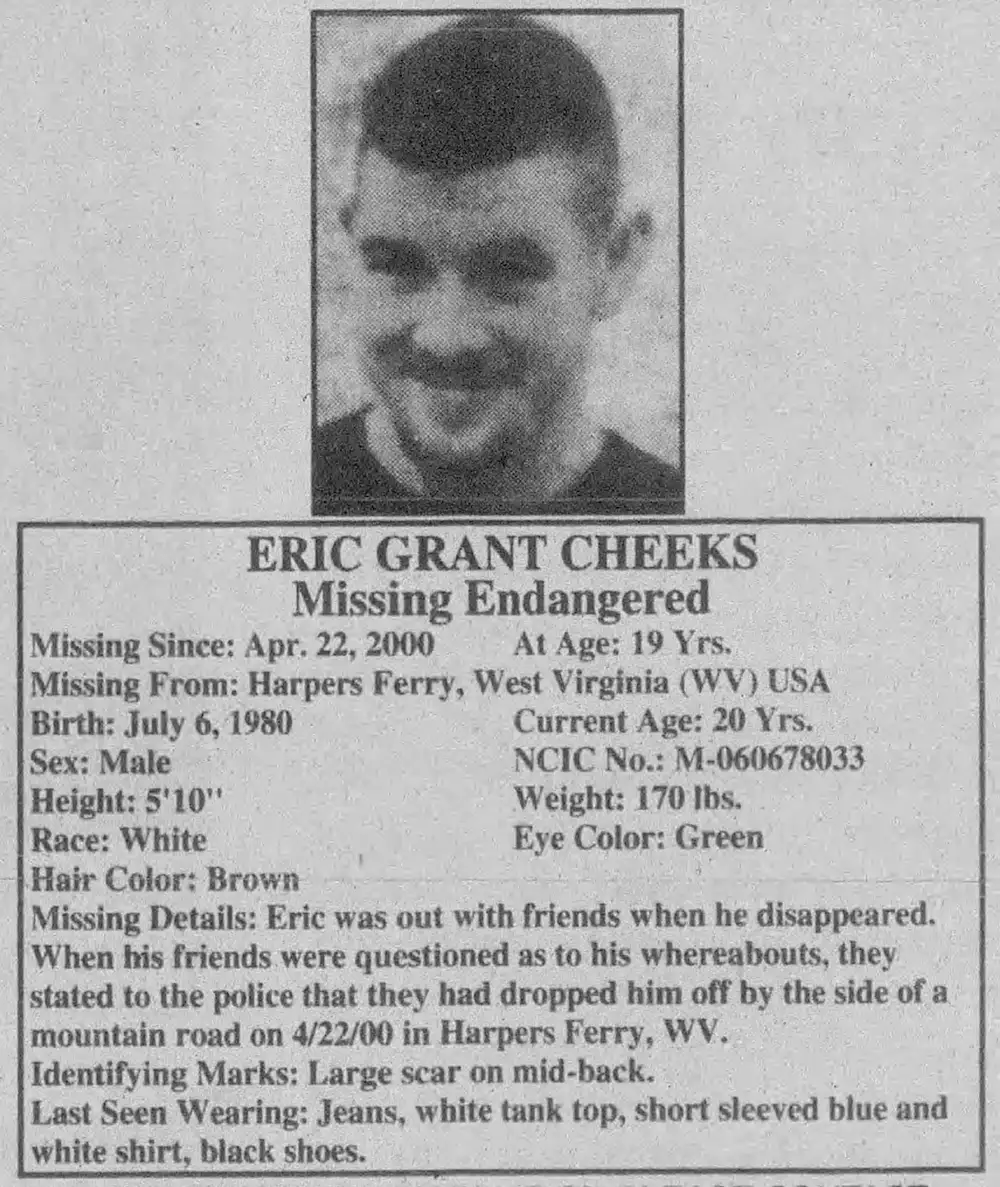 A missing person flyer for Eric Grant Cheeks titled 'Missing Endangered.' It includes a photo of Eric smiling and details about his disappearance on April 22, 2000, from Harpers Ferry, West Virginia. The flyer lists his height (5'10"), weight (170 lbs), eye color (green), and a description of his clothing at the time: jeans, a white tank top, a short-sleeved blue and white shirt, and black shoes. Additional details mention a large scar on his mid-back and note that friends claimed to have dropped him off on a mountain road in Harpers Ferry.