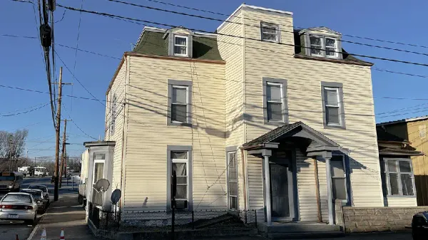 Former Fritts Apartments in Charles Town, West Virginia, a three-story light-colored corner building where Amelia Wilson lived at the time of her murder.